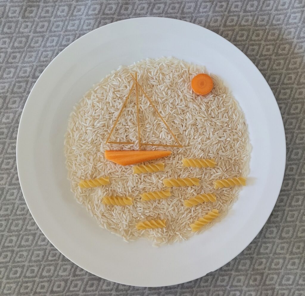 Pictures made with food a pasta boat sails in a sea of rice